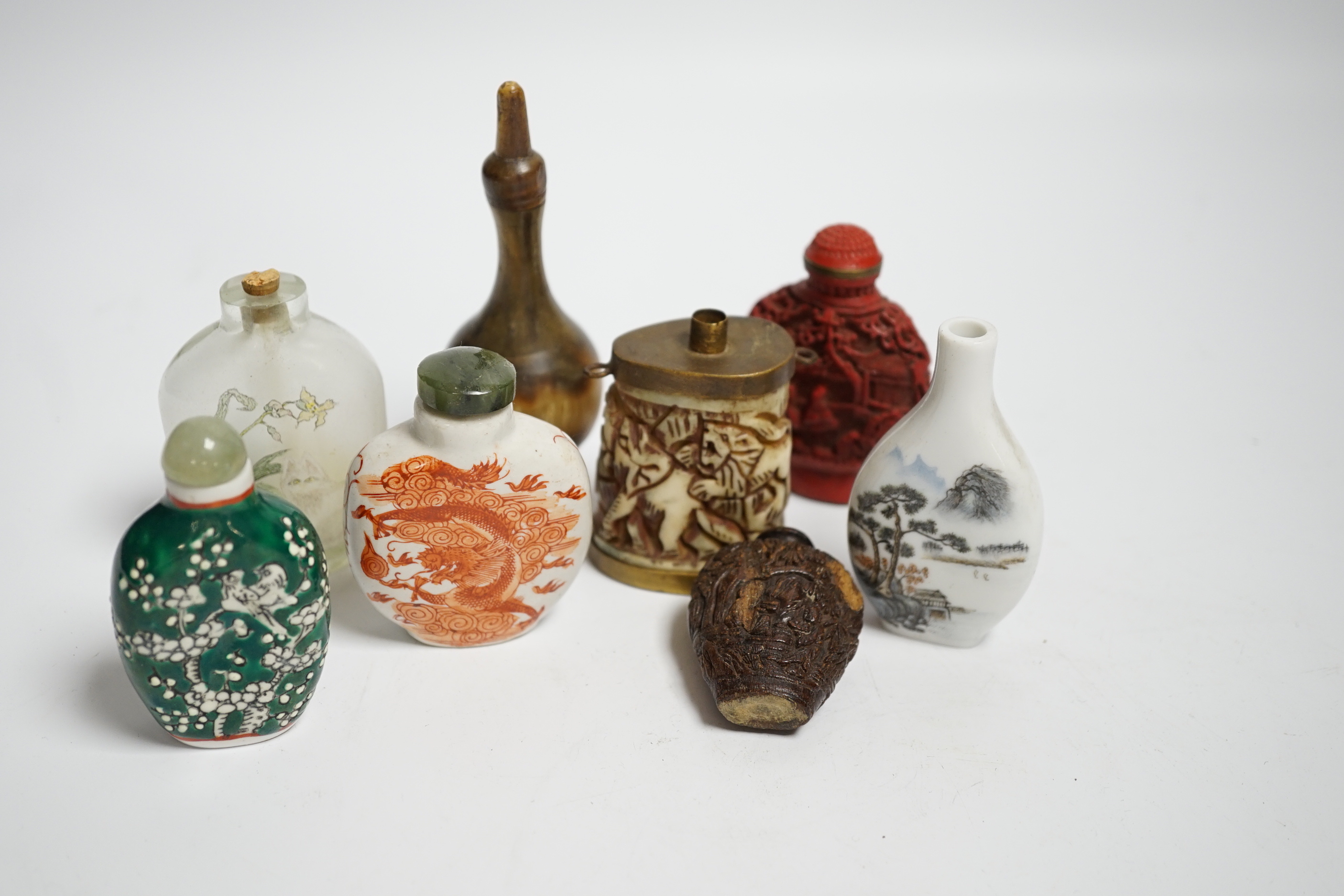 Seven various Chinese snuff bottles including horn, simulated lacquer, porcelain, glass, wood and a small bone powder flask